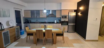 a kitchen with a wooden table and chairs in it at Apartamento mj in Santa Maria