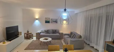 a living room with a couch and a tv at Apartamento mj in Santa Maria