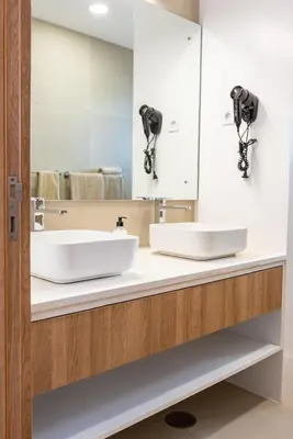 a bathroom with two sinks and a mirror at Bordão Apartments in Praia
