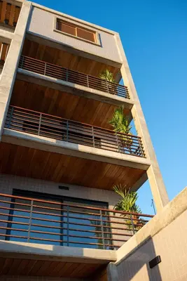 an apartment building with plants on the balconies at Bordão Apartments in Praia