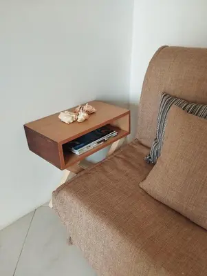 a side table next to a couch and a chair at Kite Sal in Santa Maria