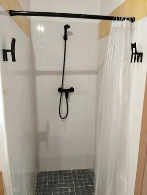 a shower with a shower curtain in a bathroom at Kite Sal in Santa Maria