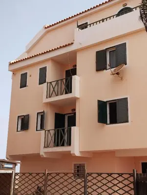 a building with black windows and a fence at Kite Sal in Santa Maria