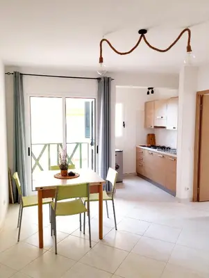 a kitchen and dining room with a table and chairs at Kite Sal in Santa Maria