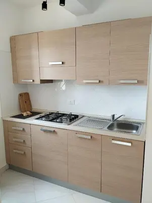 a kitchen with wooden cabinets and a sink at Kite Sal in Santa Maria