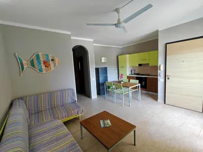 a living room with a couch and a table at Sal service green moradias residence with pool in Santa Maria