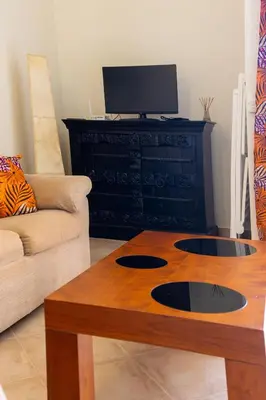a living room with a couch and a coffee table at Aparthotel Tropical Bounty Beach L02 in Santa Maria