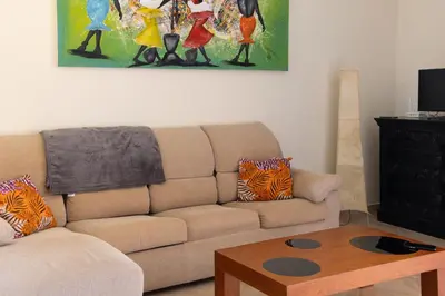 a living room with a couch and a table at Aparthotel Tropical Bounty Beach L02 in Santa Maria
