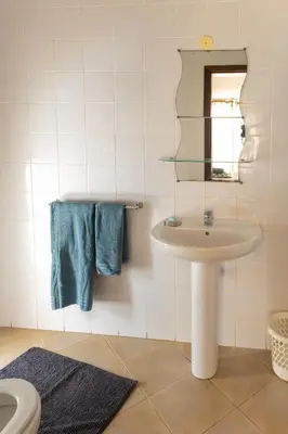 a bathroom with a sink and a mirror at Santa Maria Residence in Santa Maria