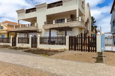 a house with a black fence in front of it at Santa Maria Residence in Santa Maria