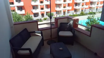 a balcony with a couch and chairs on a building at Brito Place in Santa Maria