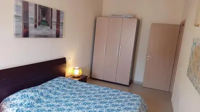 a bedroom with a bed and a cabinet and a lamp at Brito Place in Santa Maria