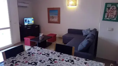 a living room with a couch and a table at Brito Place in Santa Maria