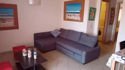 a living room with a couch and a table at Brito Place in Santa Maria