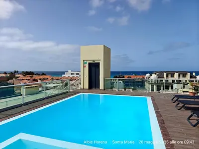 a swimming pool on the roof of a building at Albis Harena - In Sal in Santa Maria
