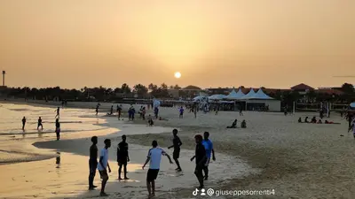 a group of people playing soccer on the beach at sunset at Albis Harena - In Sal in Santa Maria