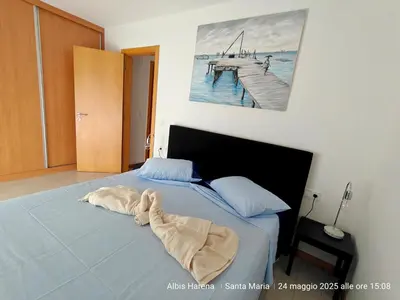 a bed with a blanket laying on top of it at Albis Harena - In Sal in Santa Maria