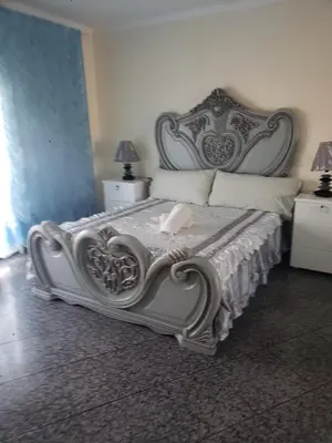 a bedroom with a bed with a large headboard at Appartement avec Vue sur Mer à Praia, Wi-Fi, Navette Aéroport avec supplément in Praia