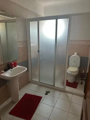 a bathroom with a shower and a toilet and a sink at Appartement avec Vue sur Mer à Praia, Wi-Fi, Navette Aéroport avec supplément in Praia