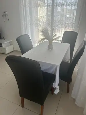 a white table with chairs and a plant on it at Appartement avec Vue sur Mer à Praia, Wi-Fi, Navette Aéroport avec supplément in Praia