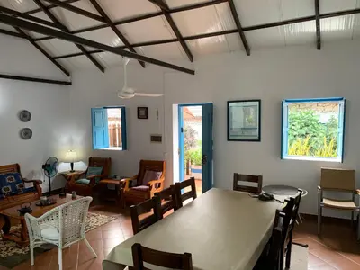 a living room with a table and chairs at Casinha Azul Cidade Velha - Blue House Old Town in Cidade Velha