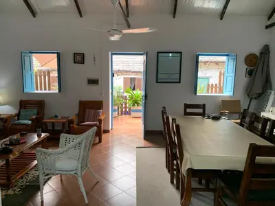 a dining room with a table and chairs at Casinha Azul Cidade Velha - Blue House Old Town in Cidade Velha