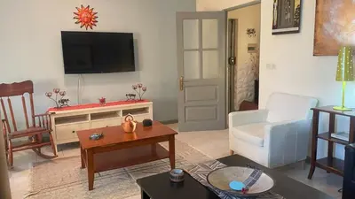a living room with a couch and a tv at Girassol Tarrafal Apartment in Tarrafal