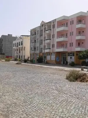 an empty street in front of a building at Girassol Tarrafal Apartment in Tarrafal