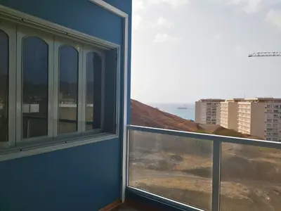 a room with a window with a view of the ocean at Residencial Alto do Fortim in Mindelo