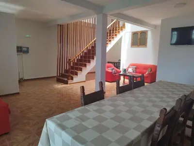a dining room with a checkered table and chairs at Residencial Alto do Fortim in Mindelo