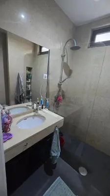 a bathroom with a sink and a shower at Family apartment with pool in Praia