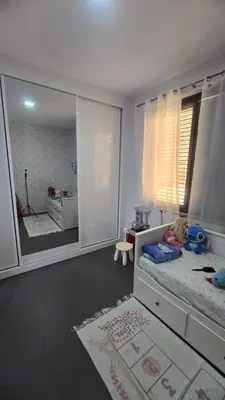 a bedroom with a bed with a large mirror at Family apartment with pool in Praia