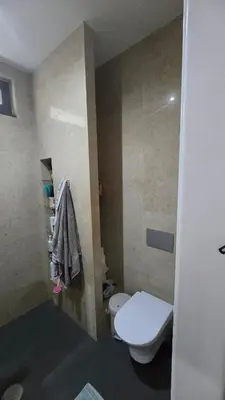 a small bathroom with a toilet and a sink at Family apartment with pool in Praia