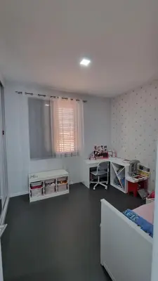 a room with a bedroom with a bed and a desk at Family apartment with pool in Praia