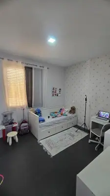 a bedroom with a bed and a table and a desk at Family apartment with pool in Praia