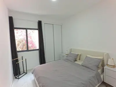 a white bedroom with a bed and a window at Casa Guido T3, 3 Bedroom in Santa Maria