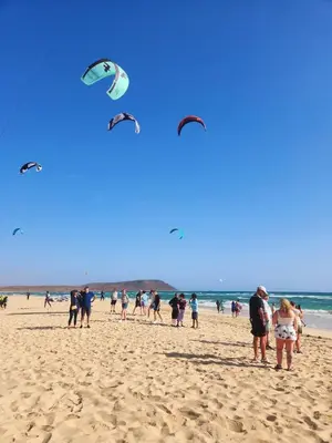 a group of people on the beach flying kites at Casa Guido T3, 3 Bedroom in Santa Maria
