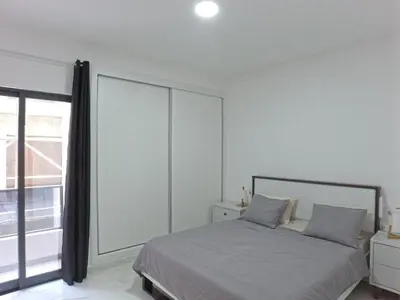 a bedroom with a bed and a large window at Casa Guido T3, 3 Bedroom in Santa Maria