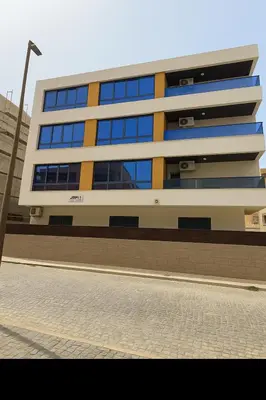 a large building with blue windows on a street at Casa Guido T3, 3 Bedroom in Santa Maria