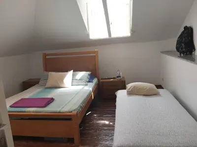a small bedroom with two beds and a window at FeliGrab in Mindelo