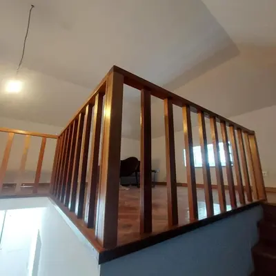a staircase with wooden railings in a house at FeliGrab in Mindelo