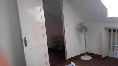 a room with a white door and a fan at FeliGrab in Mindelo