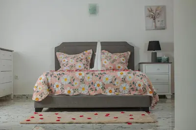 a bedroom with a bed with flowers on it at Cidade Serena in Cidade Velha