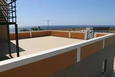 a balcony of a building with a view of the ocean at Cidade Serena in Cidade Velha