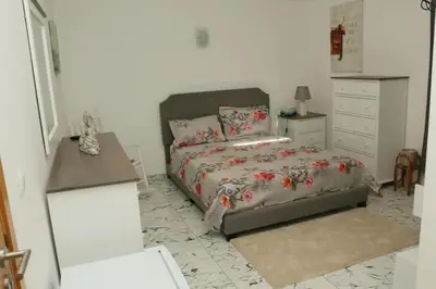 a bedroom with a bed and a dresser at Cidade Serena in Cidade Velha