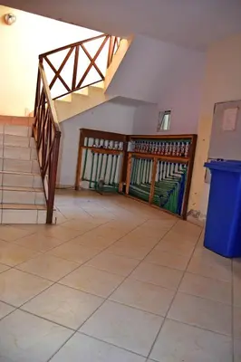 an empty room with stairs and a blue trash can at Central Apartamento Fogo 101 in Santa Maria