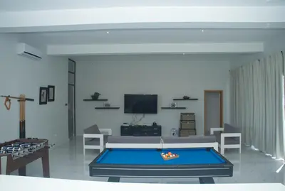 a living room with a pool table in it at The View Hotel CV in São Filipe