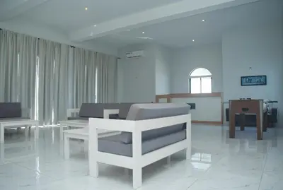 a living room with a couch and a chair at The View Hotel CV in São Filipe