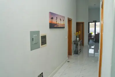 a hallway with a white wall with a picture on it at The View Hotel CV in São Filipe
