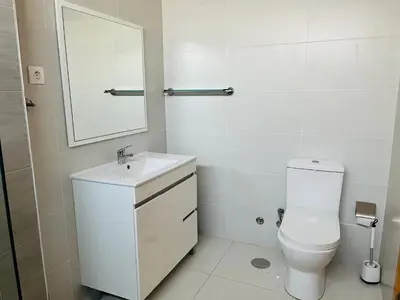 a bathroom with a toilet and a sink and a mirror at Douceur de Vie in Praia